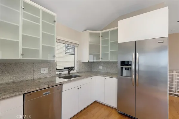 a kitchen with a refrigerator and a sink