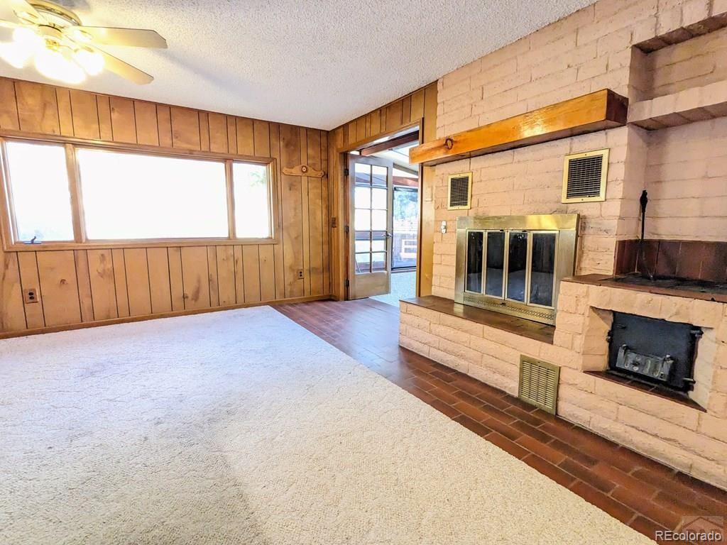 8140 Table Mountain Road Rye, CO 81069 - Photo 11 of 49 a view of an empty room with a fireplace and a window