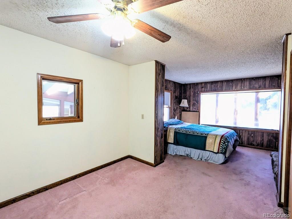 8140 Table Mountain Road Rye, CO 81069 - Photo 13 of 49 a living room with a bed furniture and a large window