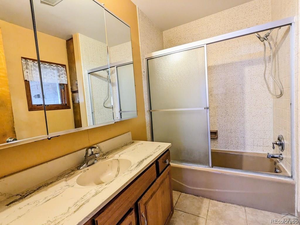 8140 Table Mountain Road Rye, CO 81069 - Photo 18 of 49 a bathroom with a granite countertop sink and a mirror