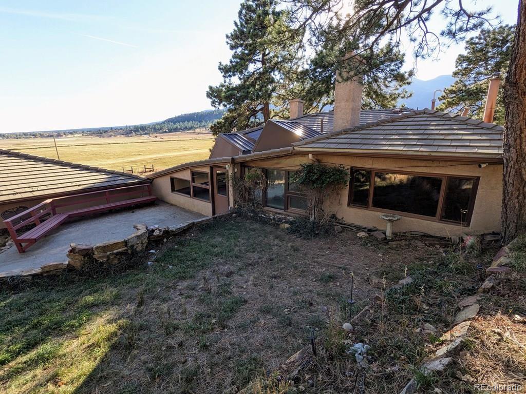 8140 Table Mountain Road Rye, CO 81069 - Photo 30 of 49 a view of a backyard with wooden fence and large trees