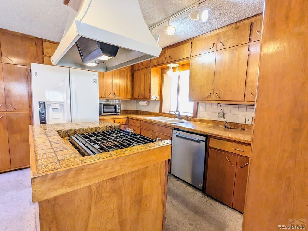 8140 Table Mountain Road Rye, CO 81069 - Photo 7 of 49 a kitchen with a stove a sink and a refrigerator