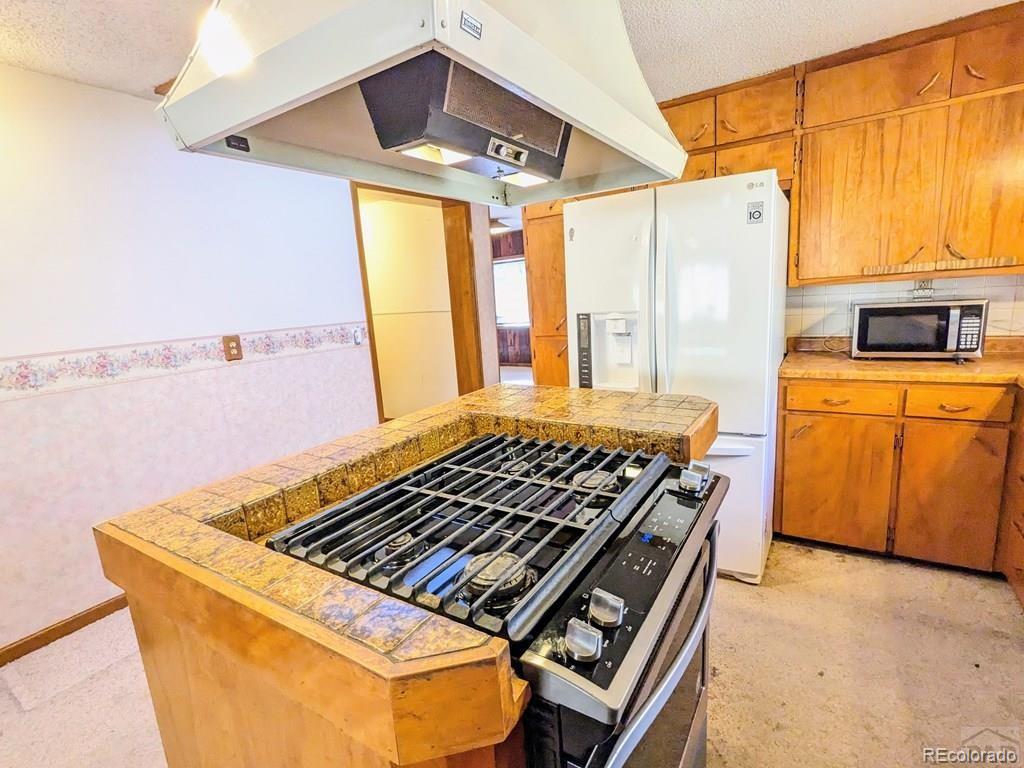 8140 Table Mountain Road Rye, CO 81069 - Photo 8 of 49 a stove top oven sitting inside of a kitchen