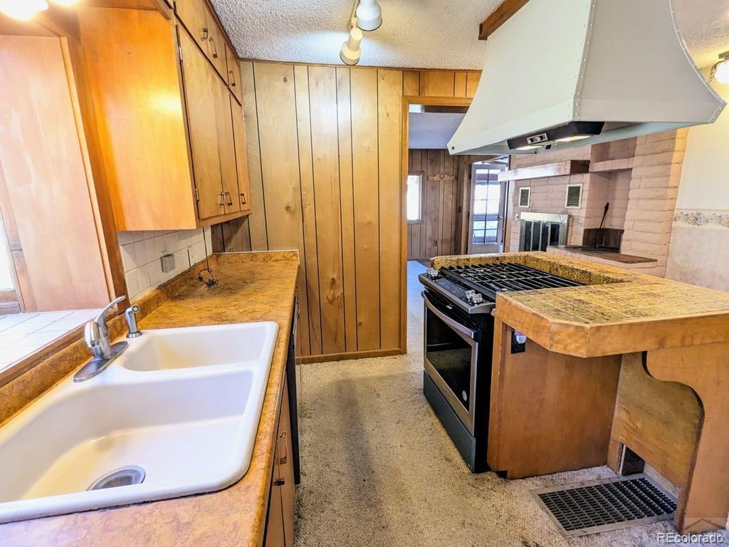 8140 Table Mountain Road Rye, CO 81069 - Photo 9 of 49 a kitchen with a sink stove and refrigerator
