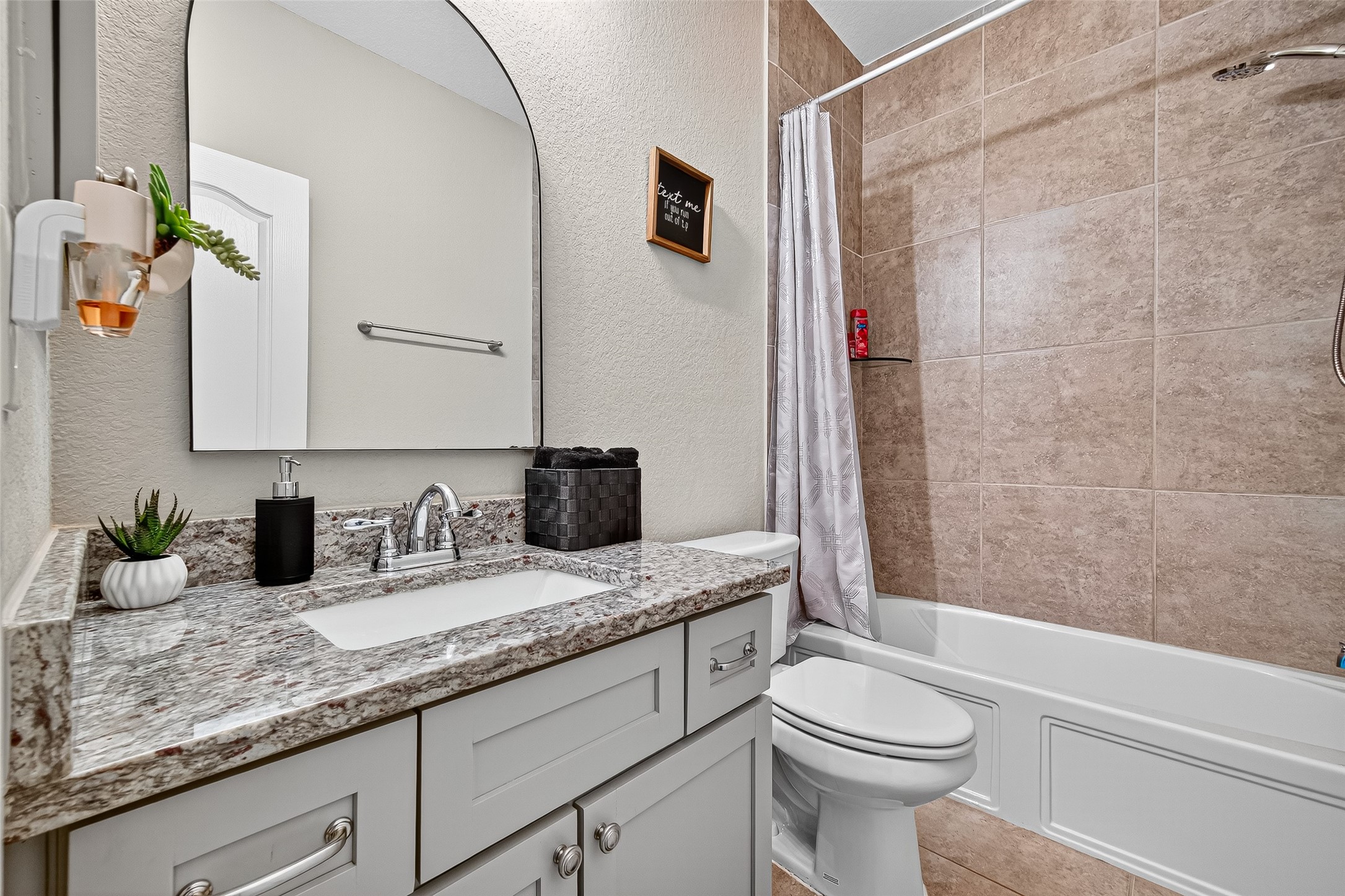 12751 Sweet Root Lane Humble, TX 77346 - Photo 18 of 29 a bathroom with a granite countertop sink a toilet and shower