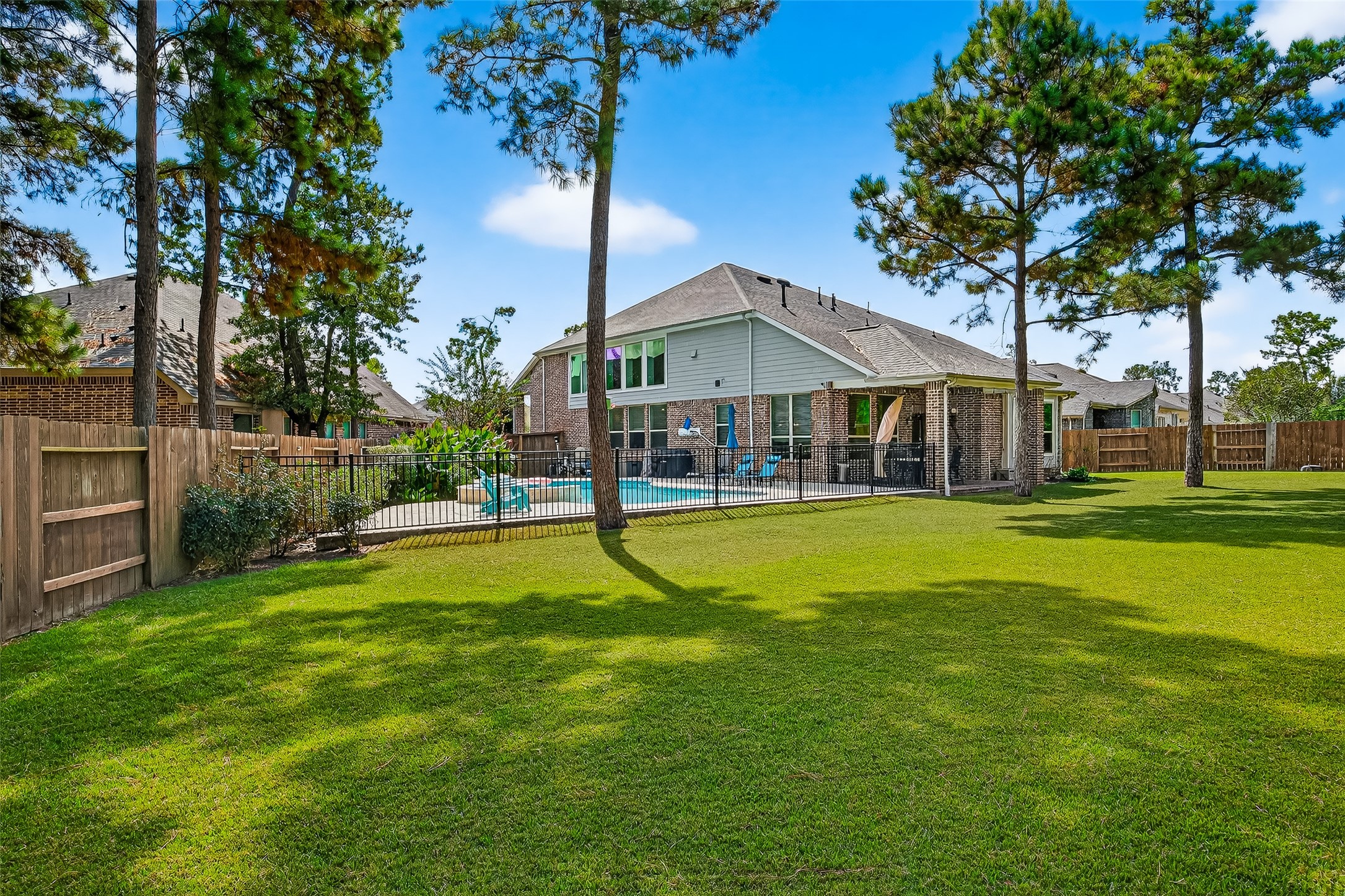 12751 Sweet Root Lane Humble, TX 77346 - Photo 25 of 29 a view of a house with a swimming pool