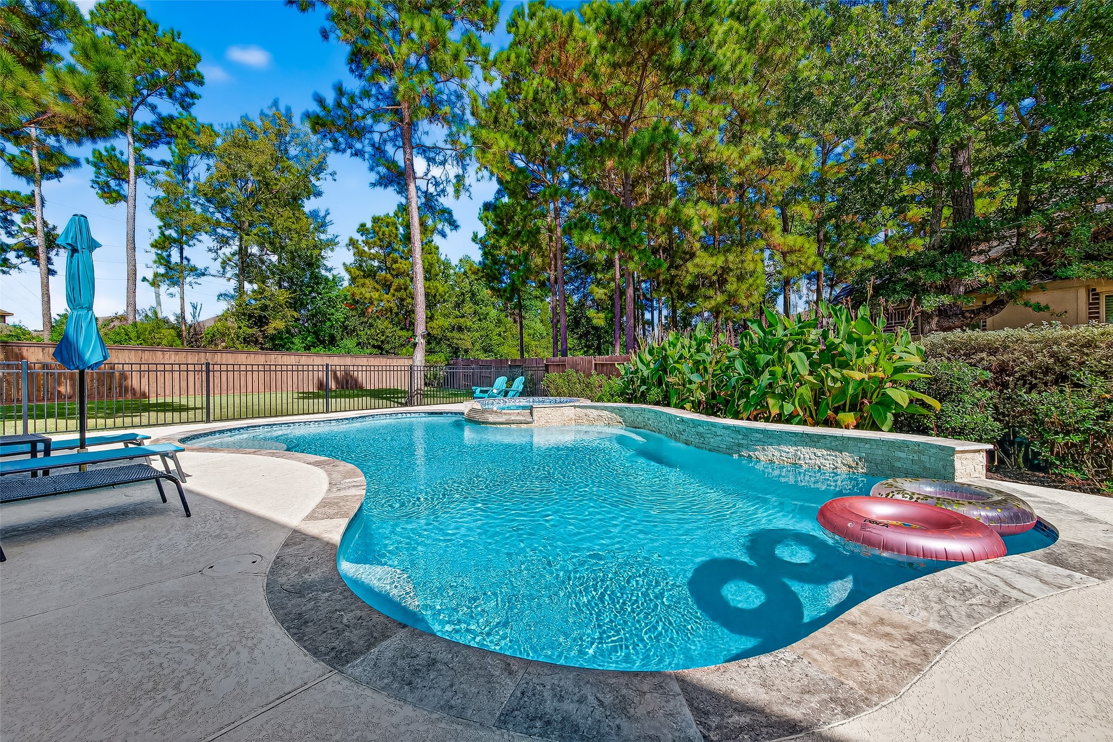 12751 Sweet Root Lane Humble, TX 77346 - Photo 3 of 29 a view of a swimming pool with a patio