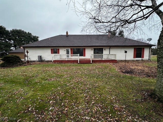 3508 Miller Road Sandusky, OH 44870 - Photo 4 of 30 Rear view of house featuring a yard, a wooden deck, and a chimney