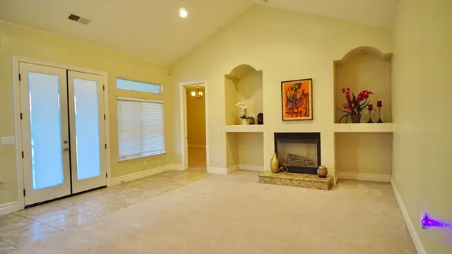 a view of an empty room with a fireplace