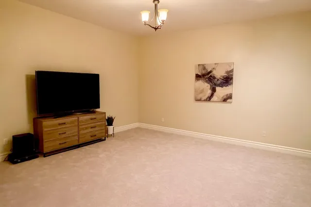 a living room with flat screen tv and a bookshelf