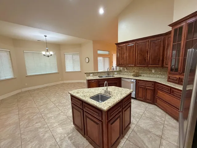 a kitchen with a stove sink and cabinets