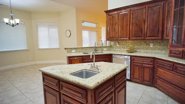 a kitchen with stainless steel appliances granite countertop wooden cabinets a sink and dishwasher