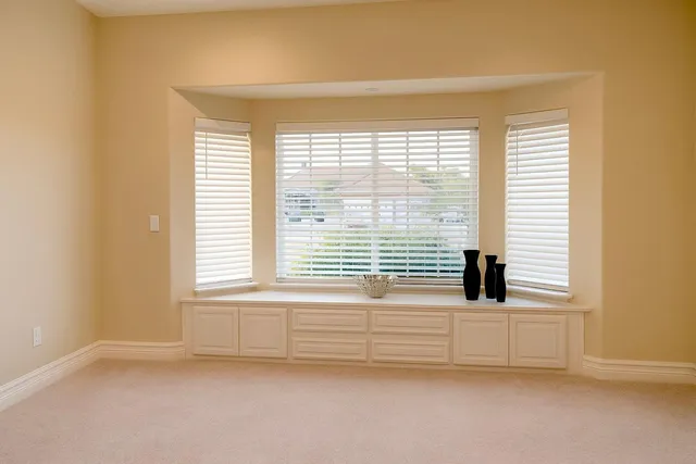 a view of an empty room with a window