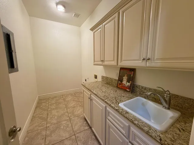 a kitchen with a sink and cabinets