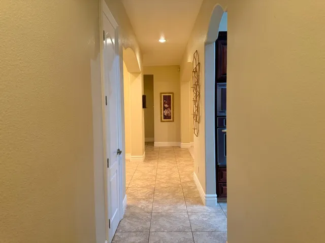 a view of a hallway with wooden shelves