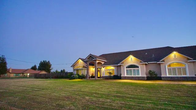 a front view of a house with a big yard