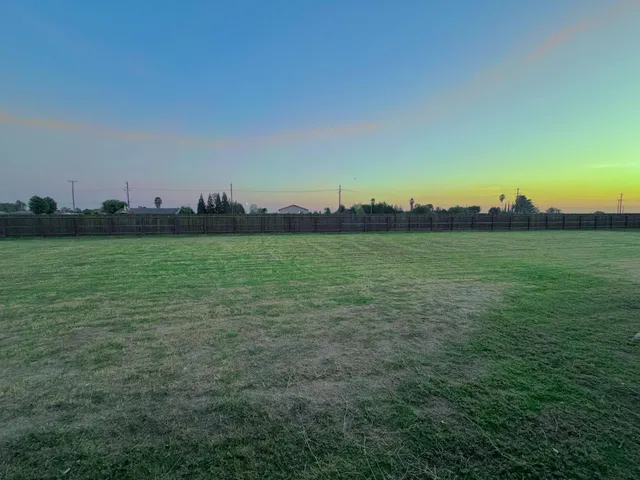 a view of a field with an ocean view