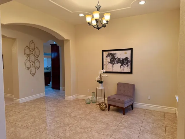 a view of a livingroom with a furniture chandelier and a window