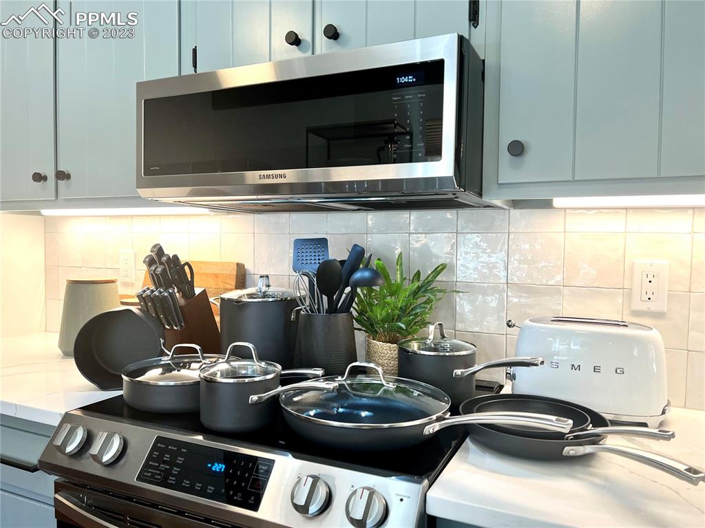 9660 Mohawk Trail Cascade, CO 80809 - Photo 14 of 42 a kitchen with a stove and a microwave