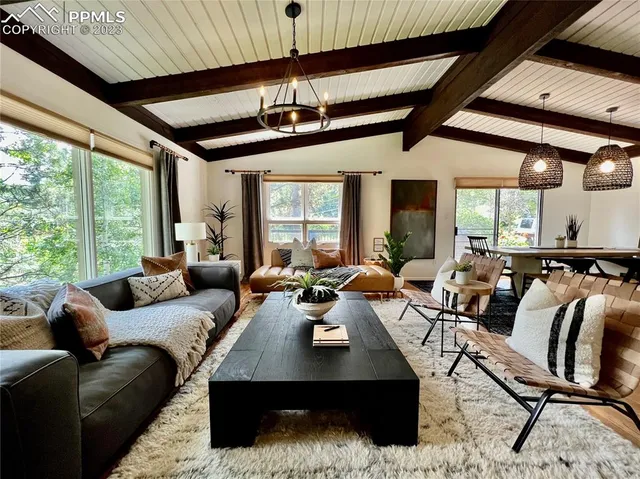 a living room with lots of furniture and a large window