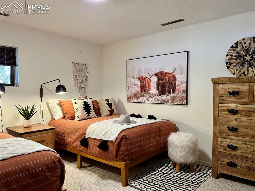 9660 Mohawk Trail Cascade, CO 80809 - Photo 32 of 42 a bedroom with two beds and painting on the wall