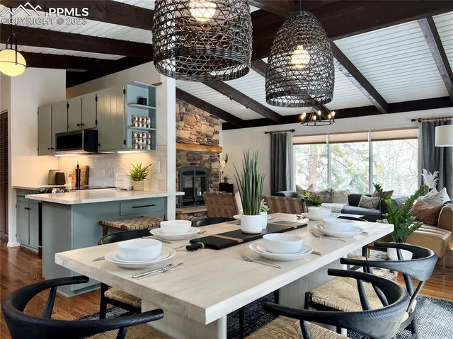 a dining room with furniture a rug and a large window