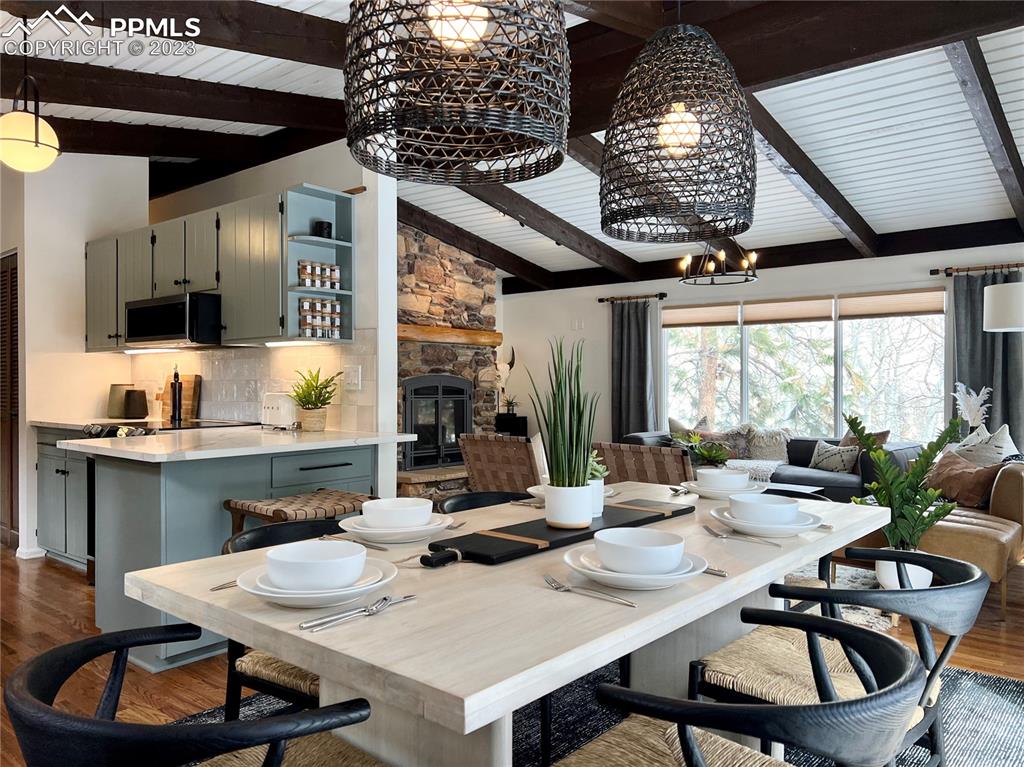 9660 Mohawk Trail Cascade, CO 80809 - Photo 4 of 42 a dining room with furniture a rug and a large window