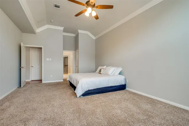 a bedroom with a bed and a chandelier fan