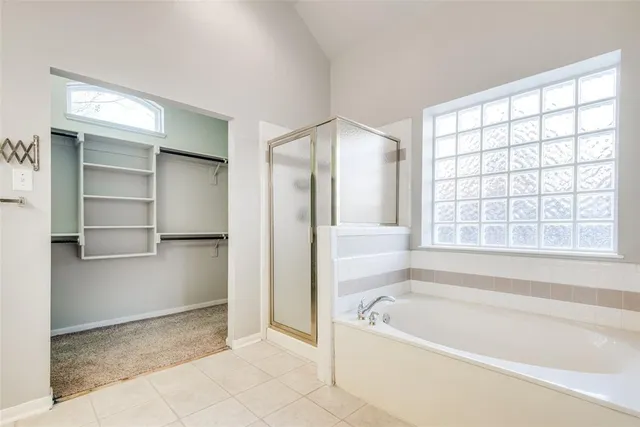 a bathroom with a bathtub and a shower