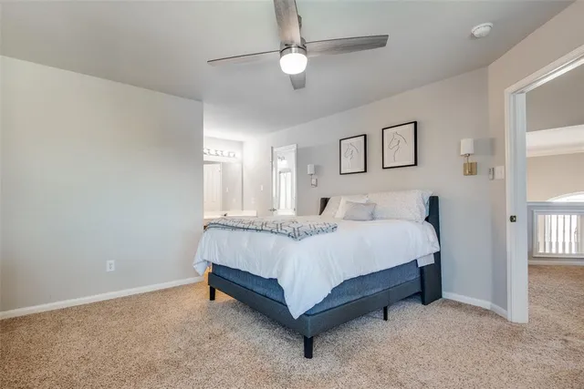 a spacious bedroom with a bed and a chandelier