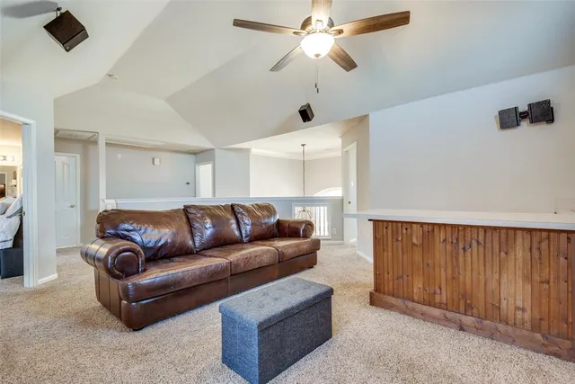 a living room with furniture and a ceiling fan
