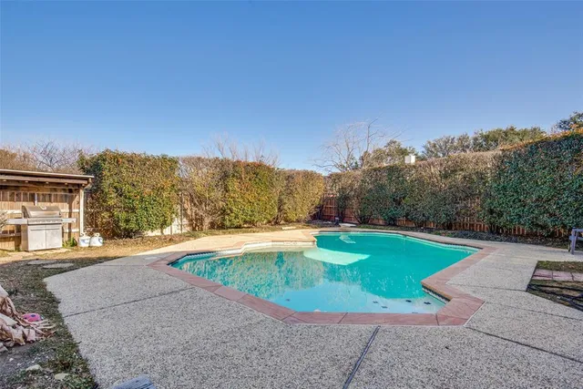 a view of a swimming pool with a yard