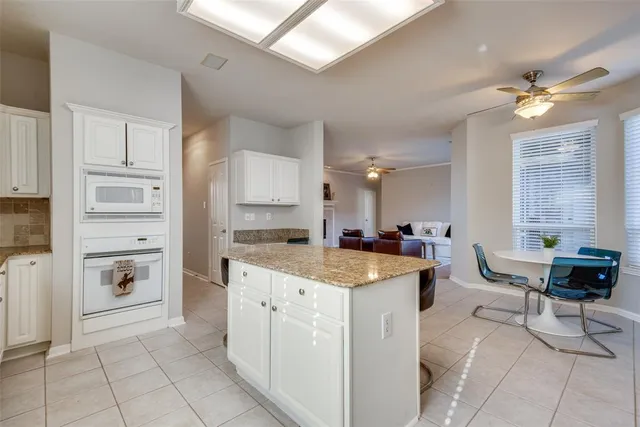 a kitchen with a stove a refrigerator and island