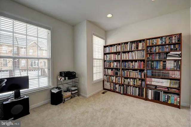 a livingroom with a book shelf and a window