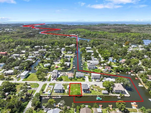 an aerial view of residential houses with outdoor space and street view