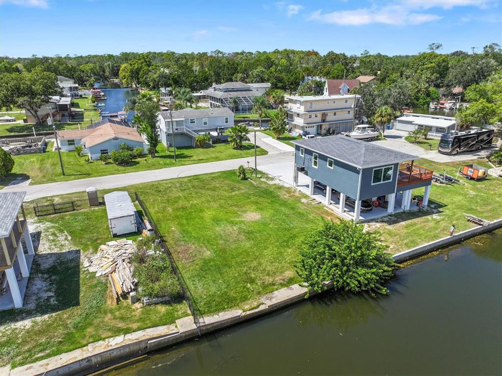6262 Island Drive Spring Hill, FL 34607 - Photo 5 of 11 an aerial view of a house with a garden and lake view
