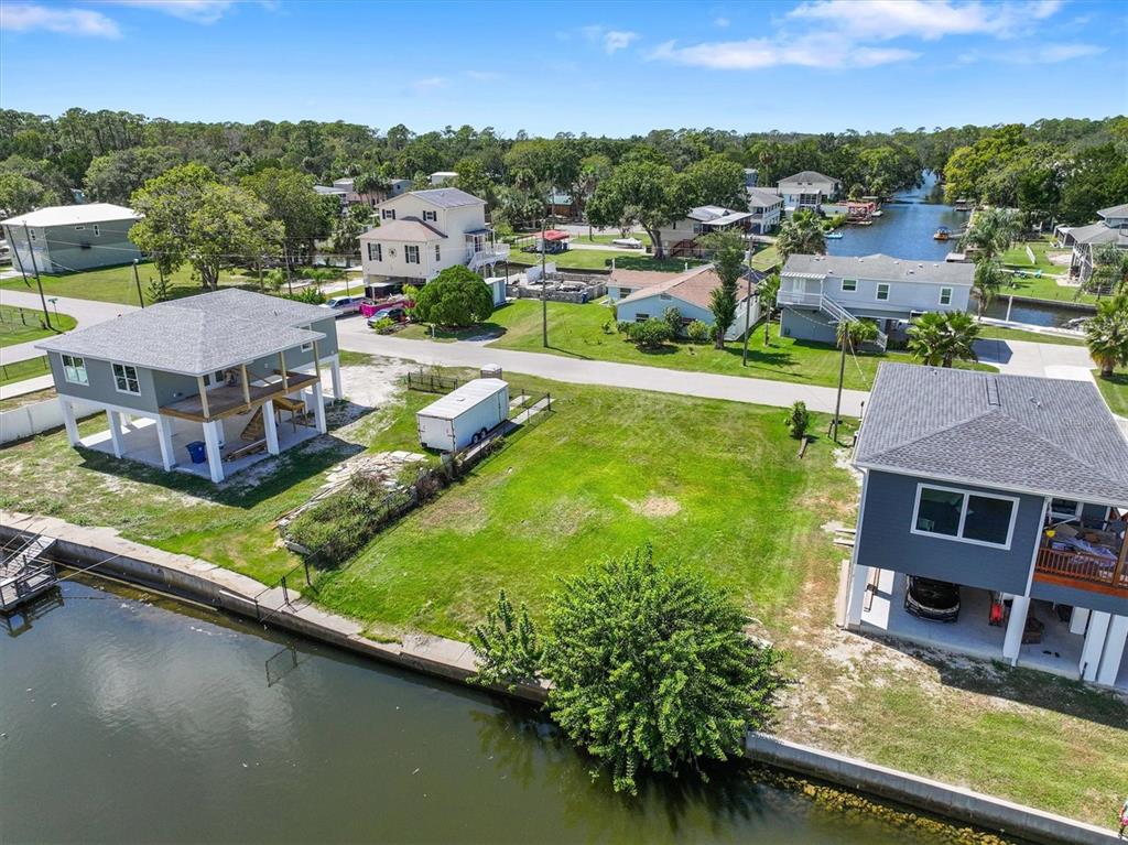 6262 Island Drive Spring Hill, FL 34607 - Photo 6 of 11 an aerial view of a house with a garden and lake view