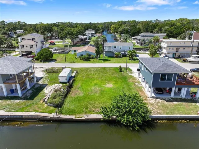 aerial view of a house with a garden and lake view