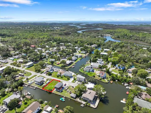 an aerial view of residential houses with outdoor space and parking