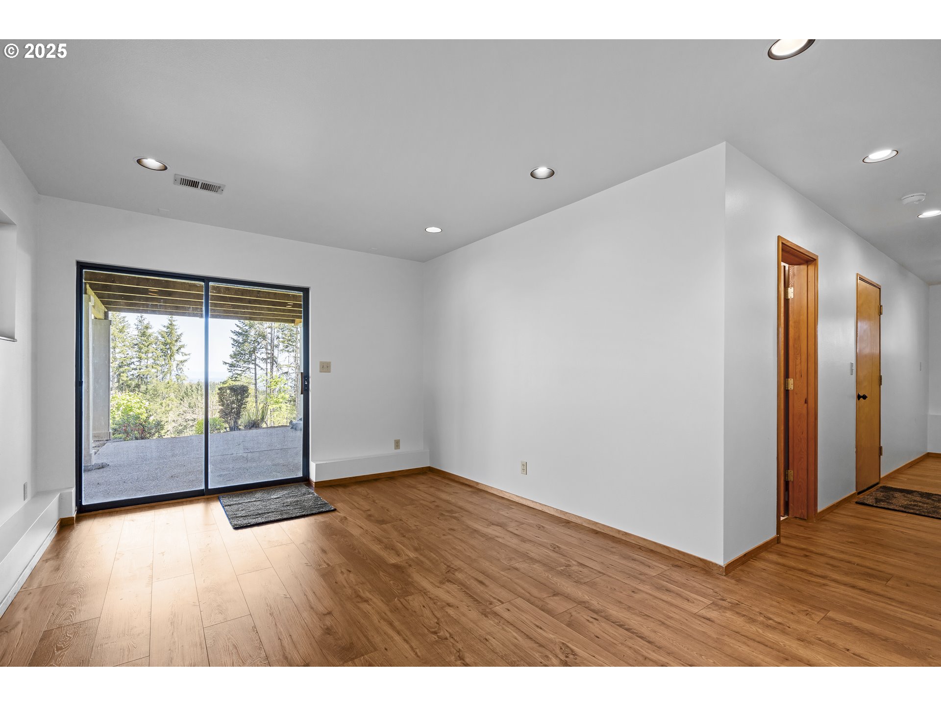 25731 Southwest Neill Road Newberg, OR 97132 - Photo 18 of 39 an empty room with wooden floor and windows