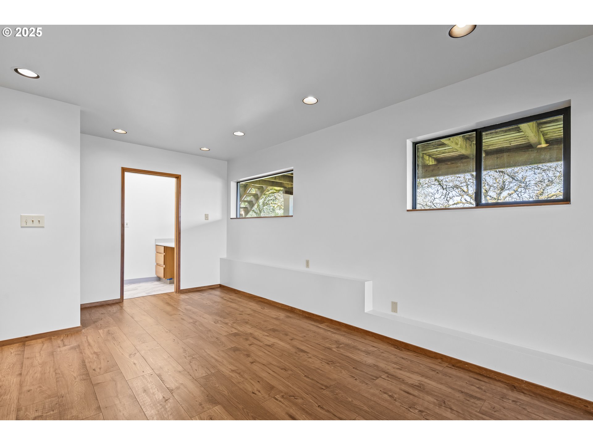 25731 Southwest Neill Road Newberg, OR 97132 - Photo 19 of 39 a view of an empty room with window and wooden floor