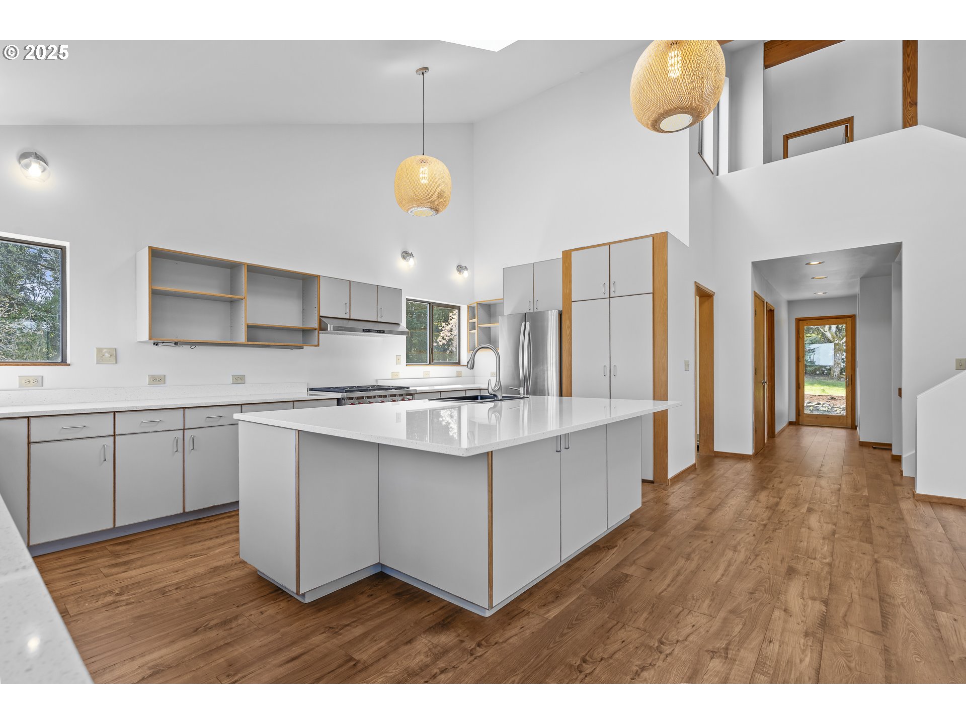 25731 Southwest Neill Road Newberg, OR 97132 - Photo 6 of 39 a kitchen with stainless steel appliances granite countertop a sink a stove top oven a chimney and a center island