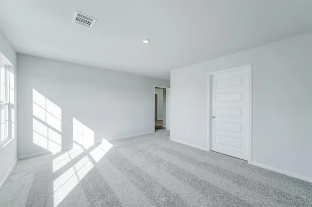 a view of an empty room and a window
