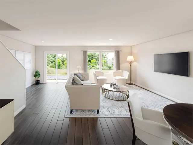 a living room with furniture a flat screen tv and a large window