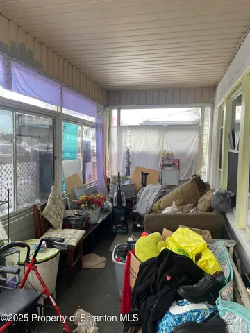 a bedroom with furniture and a large window