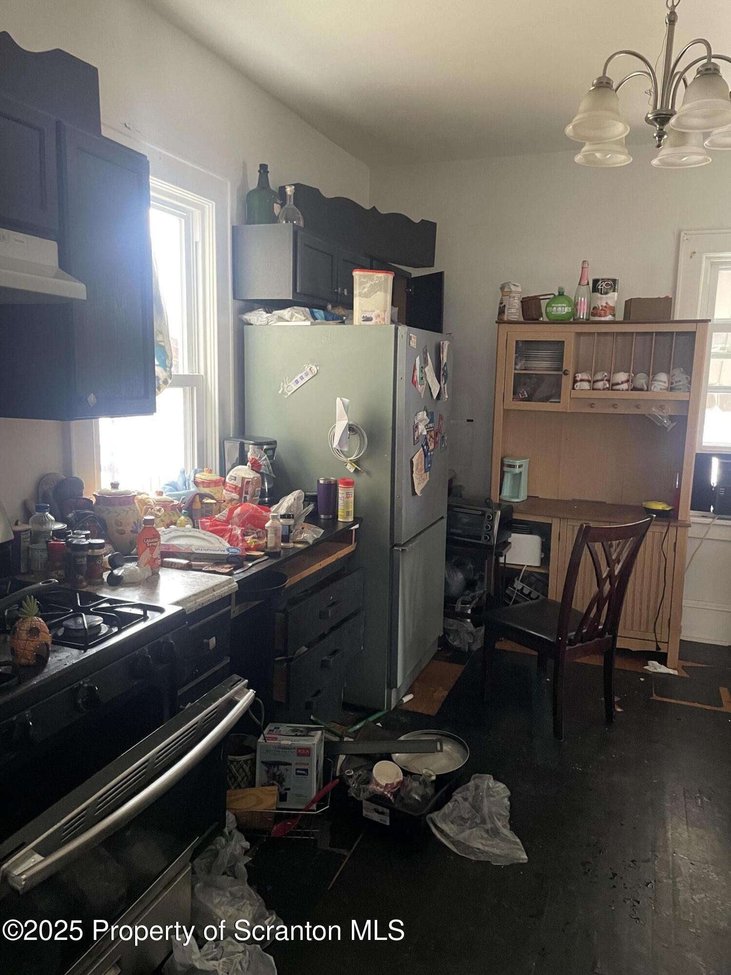 1614 Prospect Avenue Scranton, PA 18505 - Photo 3 of 9 a kitchen with a table chairs and appliances