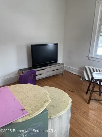 a living room with a flat screen tv and a couch