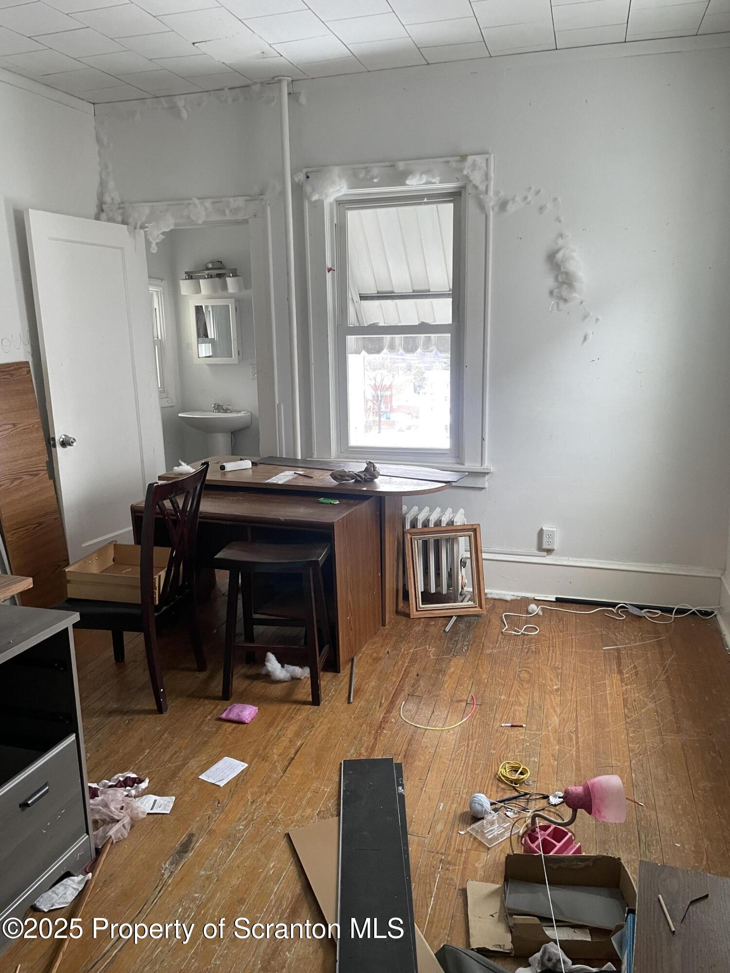 1614 Prospect Avenue Scranton, PA 18505 - Photo 5 of 9 a living room with furniture a piano and a fireplace