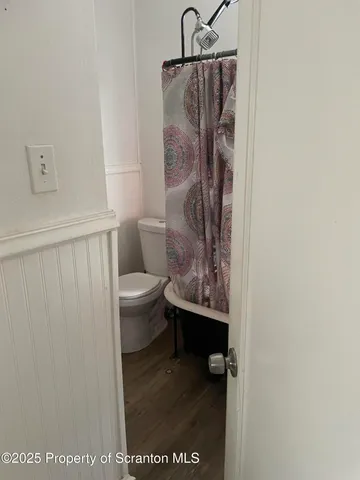a bathroom with a toilet and a shower