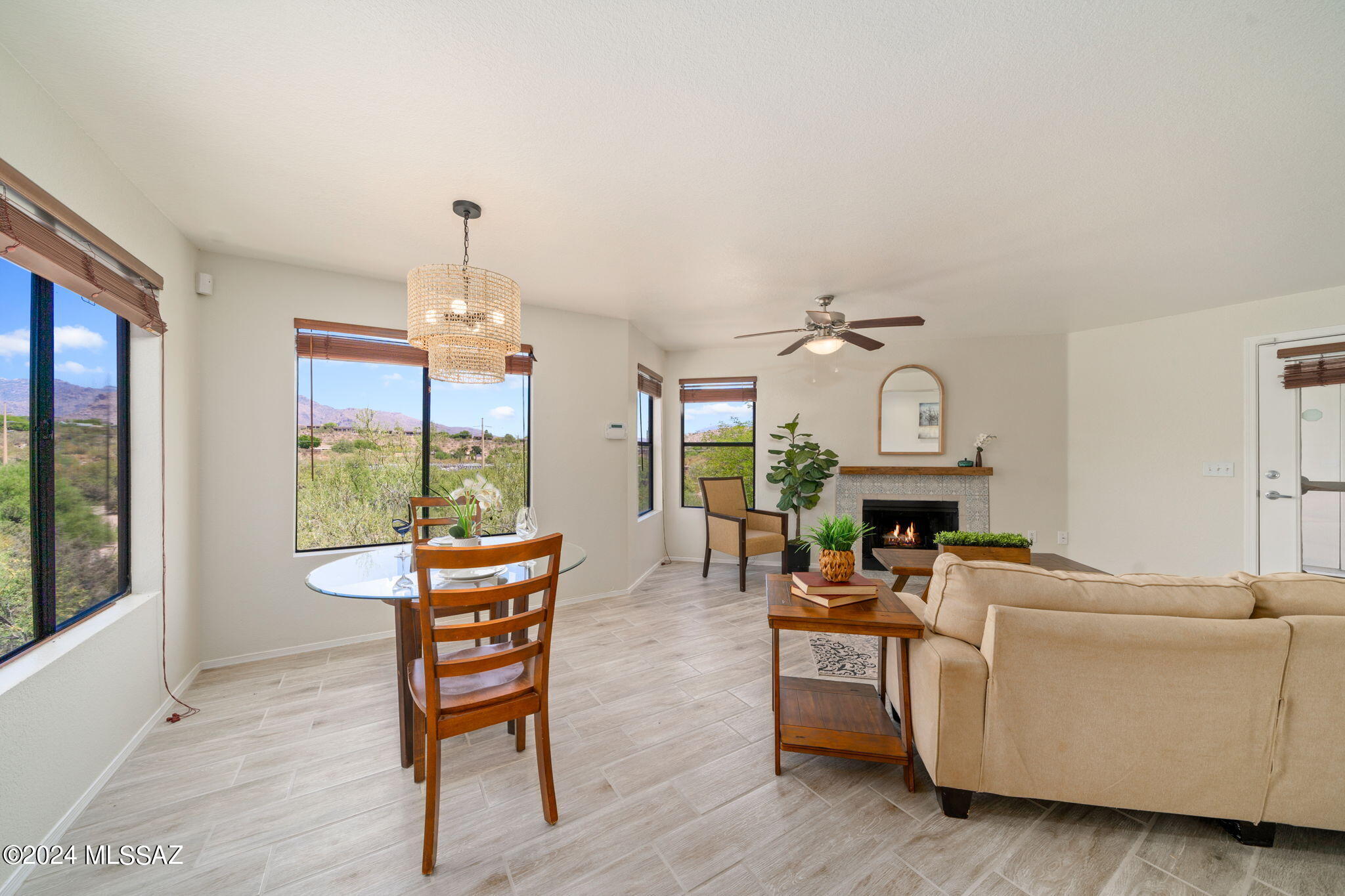 7255 East Snyder Road, Unit 4206 Tucson, AZ 85750 - Photo 5 of 33 a living room with furniture a fireplace and a chandelier